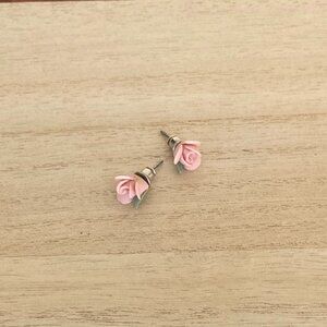 Rosebud stud earrings, delicate pink with tiny green leaves. Ceramic/Porcelain.